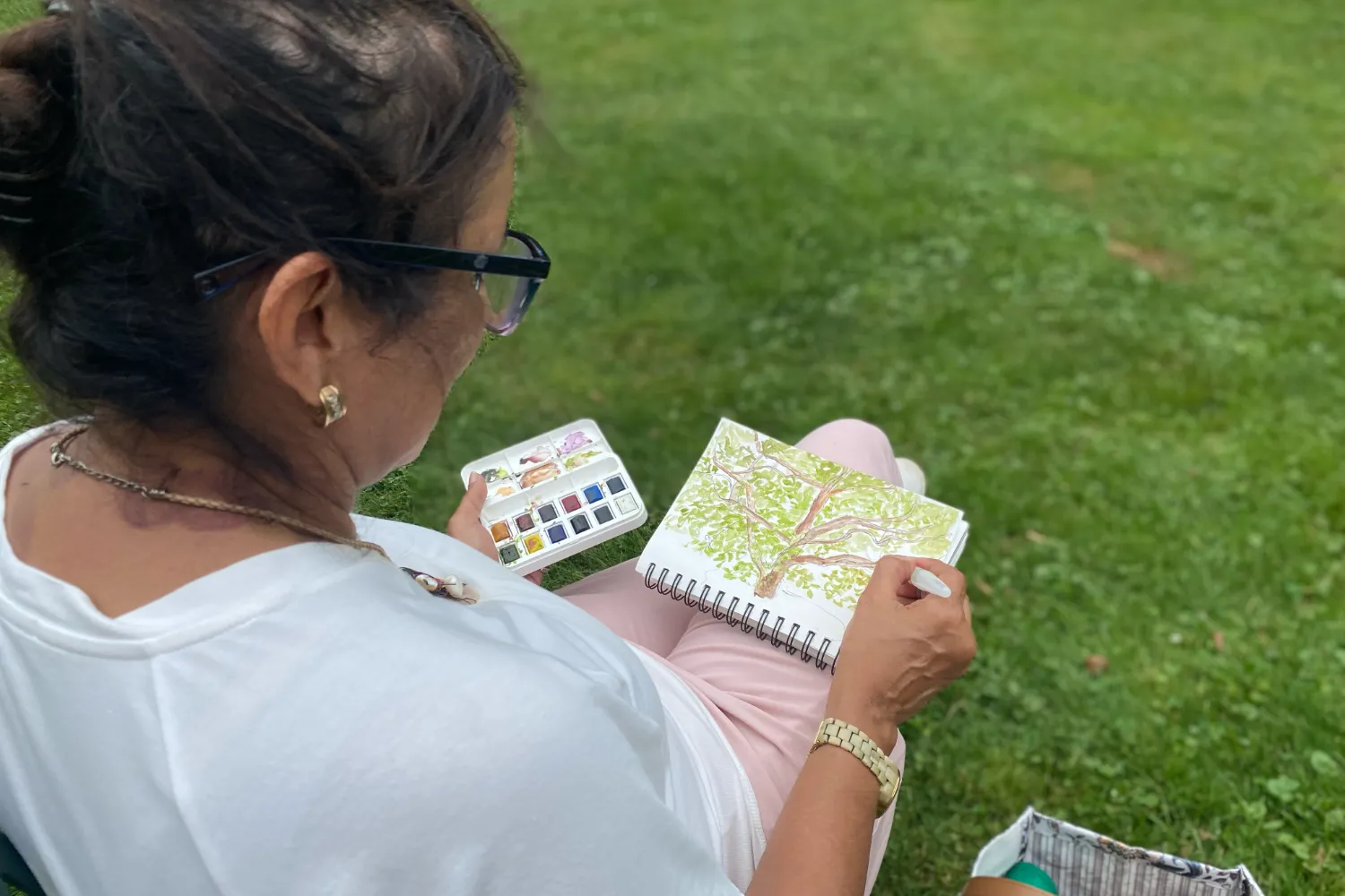 The Art of Inks & Washes Farmers Market Sketches Watercolor ink painting workshop student working in a sketchbook outdoors in Toronto.