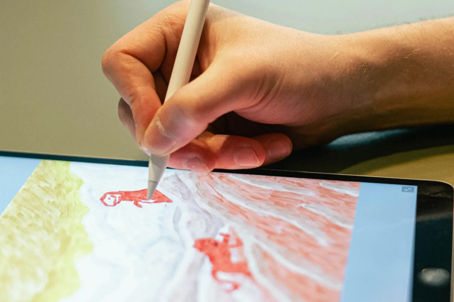 The Digital Canvas Digital art student using a stylus to create a landscape on a tablet at ARAS.