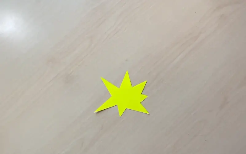Yellow cardstock with a hand-drawn jagged explosion star outlined in black Sharpie