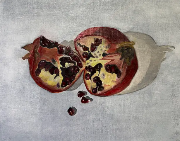 Oil painting of a sliced pomegranate with deep red seeds and yellow pith on a grey textured canvas Classical Painting Techniques at Avenue Road Arts School — Winter 2026