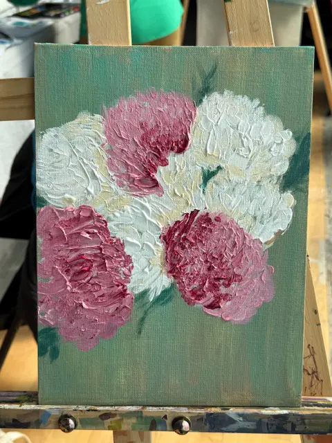Thickly textured acrylic painting of pink and white flowers on a green canvas sitting on a wooden easel Spring in Bloom at Avenue Road Arts School — Winter 2026